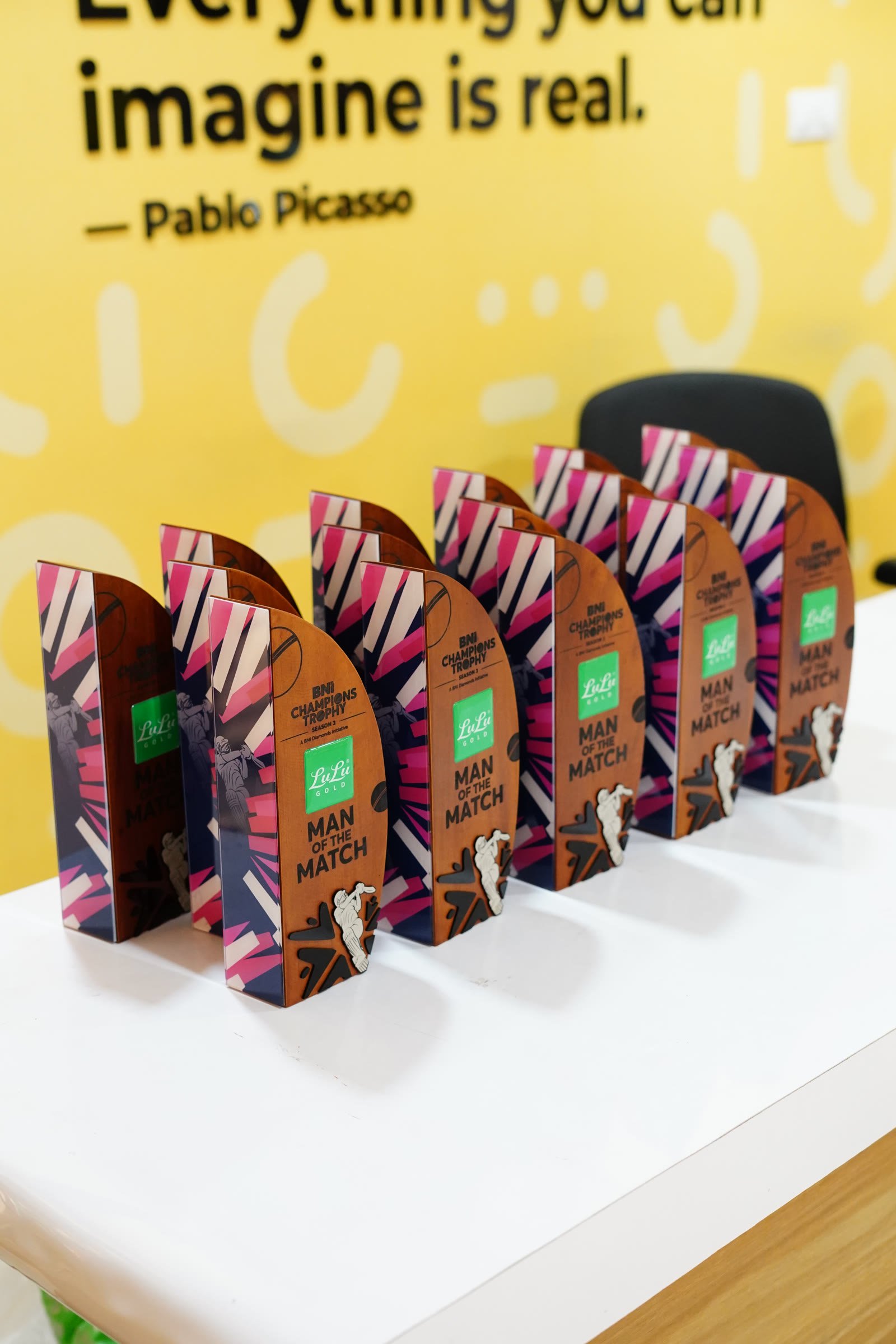 Colourful printed acrylic awards arranged as an event series