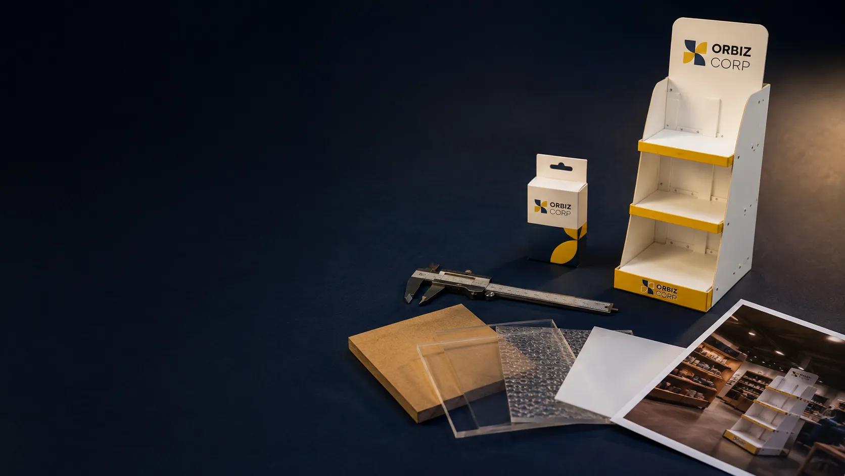 POP display analysis workbench with product pack, measuring tools, material samples and display prototype